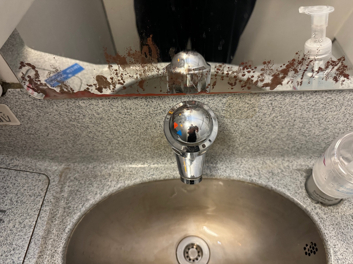 a dirty sink with a faucet