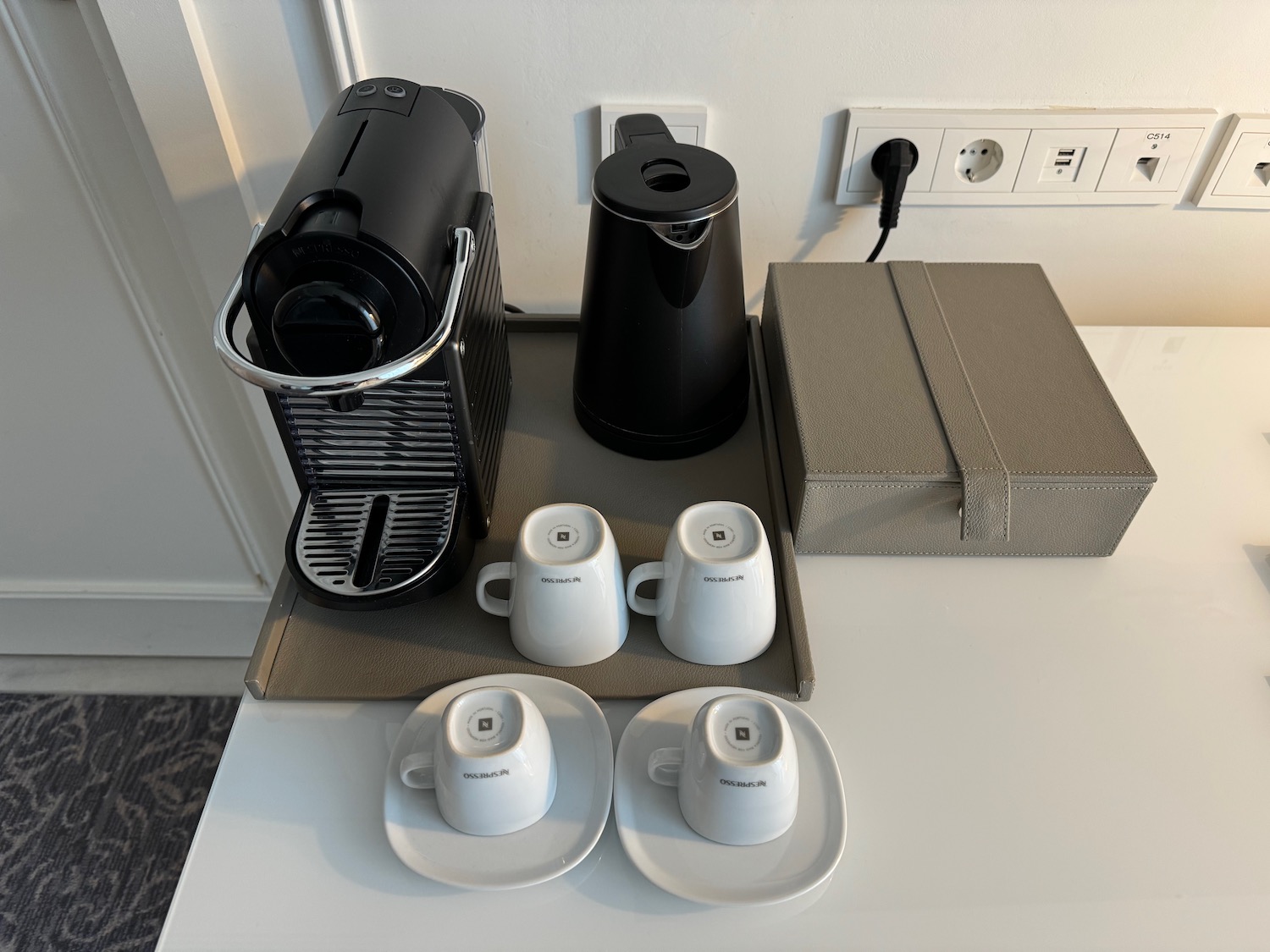 a coffee machine and cups on a table