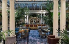 a room with tables and chairs and a chandelier