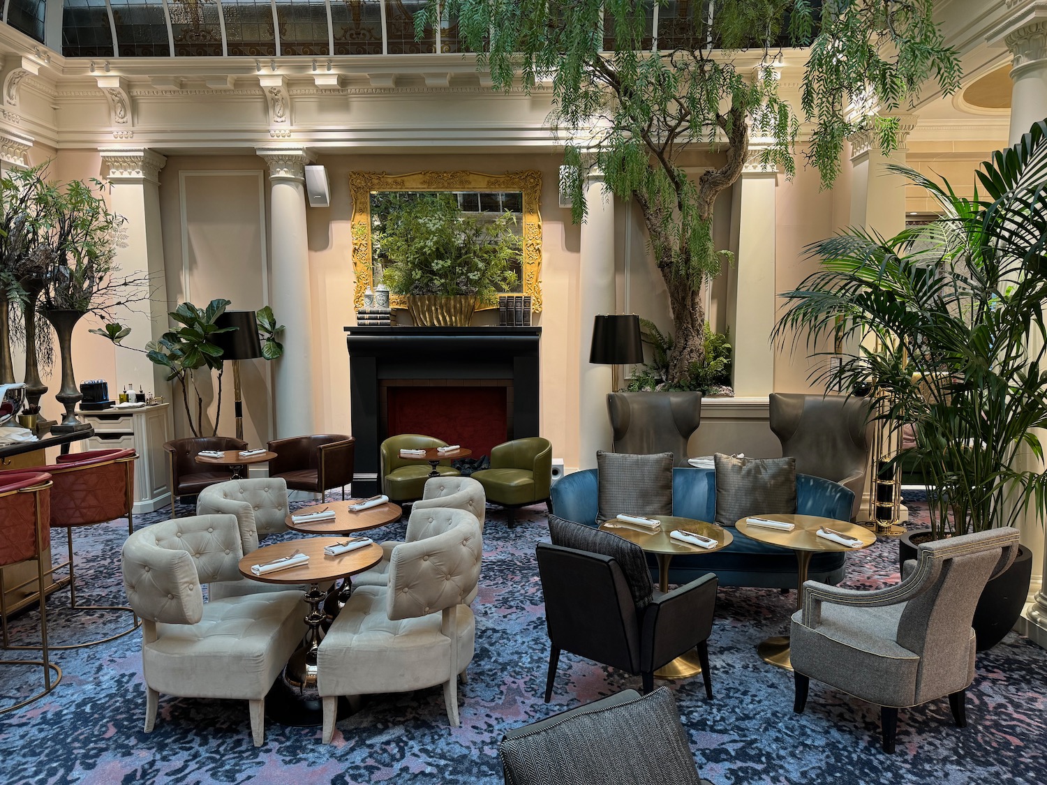 a room with a fireplace and tables and chairs