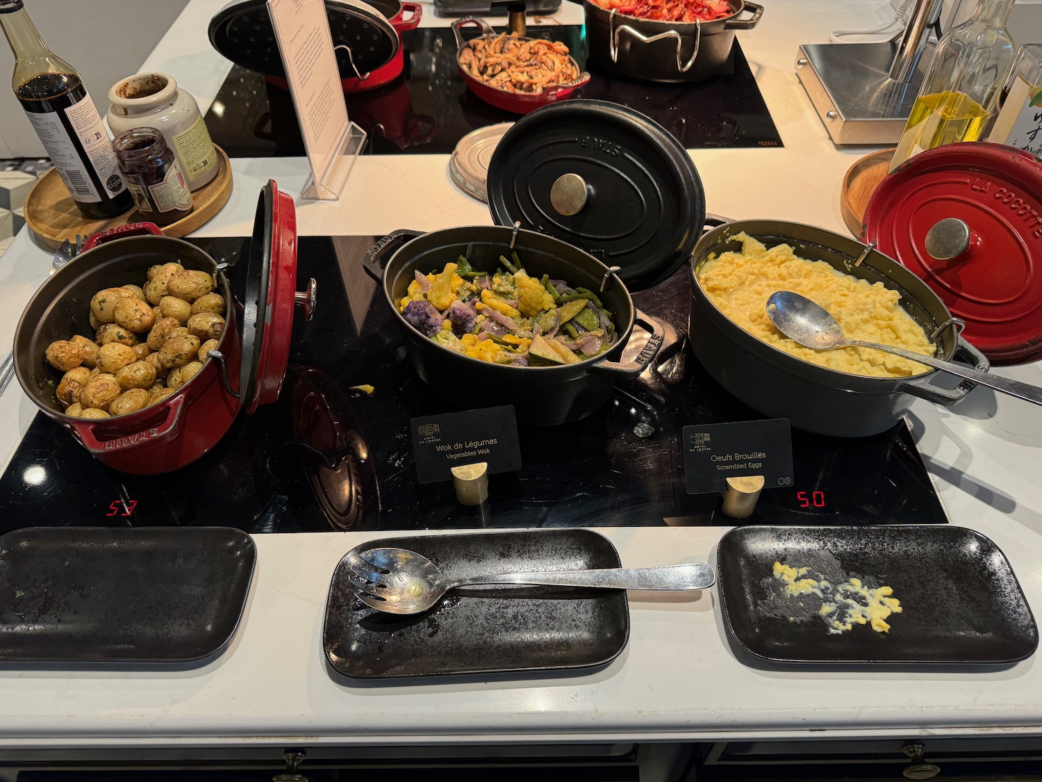 a group of pots of food on a counter