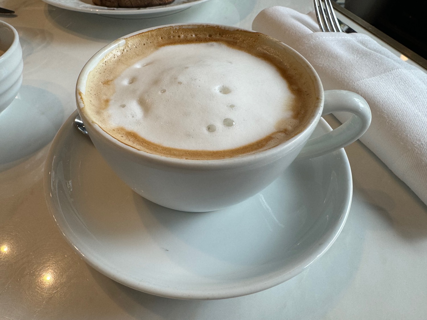 a cup of coffee with foam in it