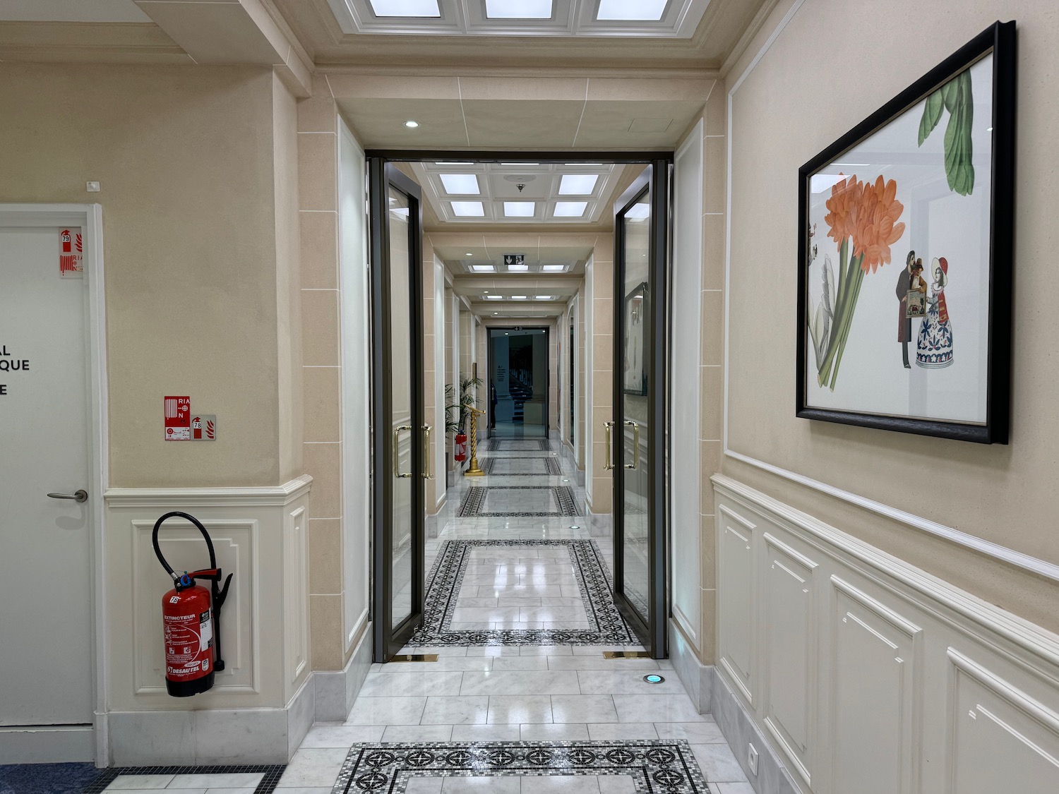 a hallway with doors and a fire extinguisher