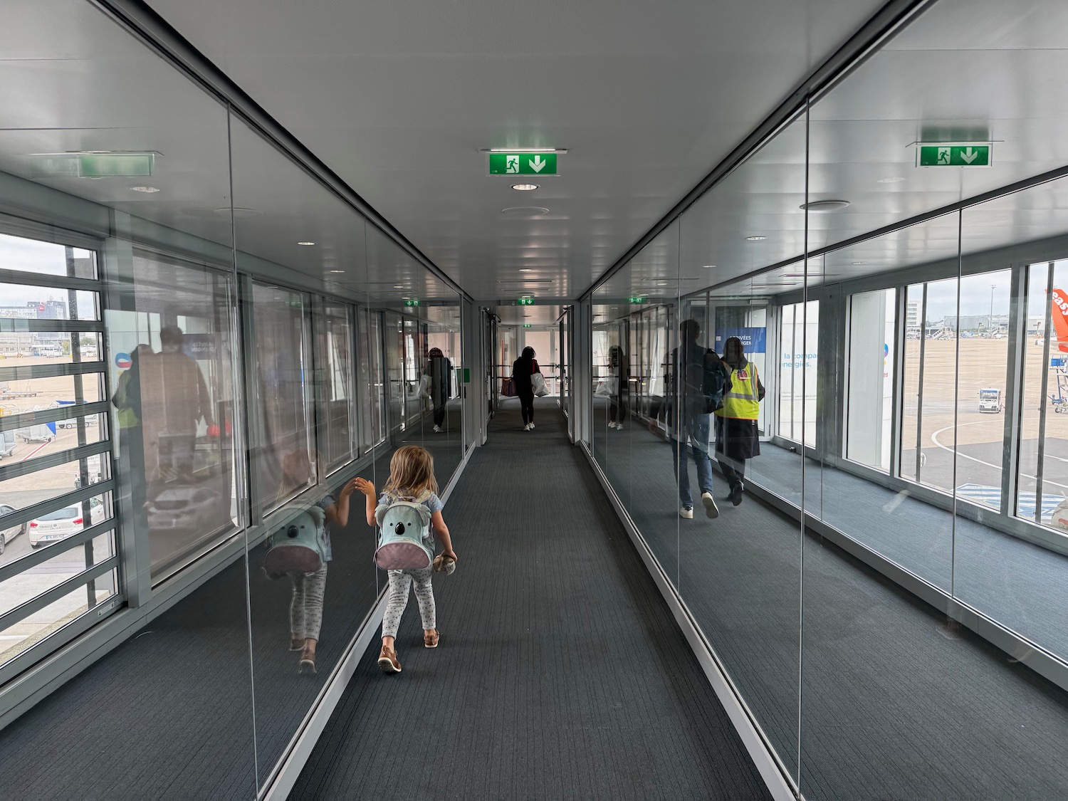 a group of people walking through a hallway