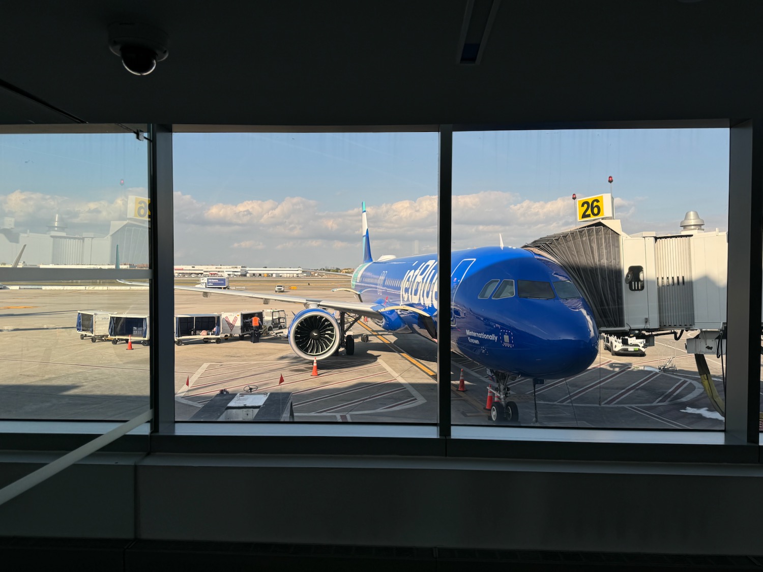 a blue airplane on the tarmac