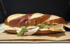 a sandwich on a paper plate