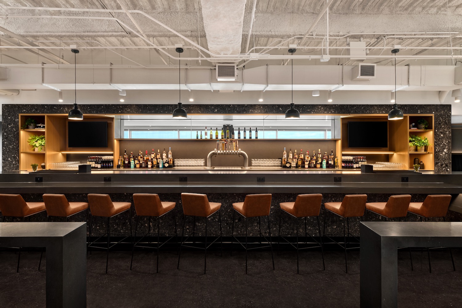 a bar with a row of chairs and a beer tap