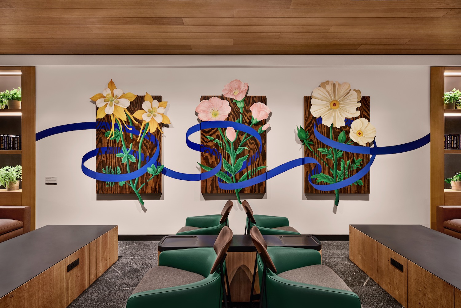 a room with chairs and tables and flowers