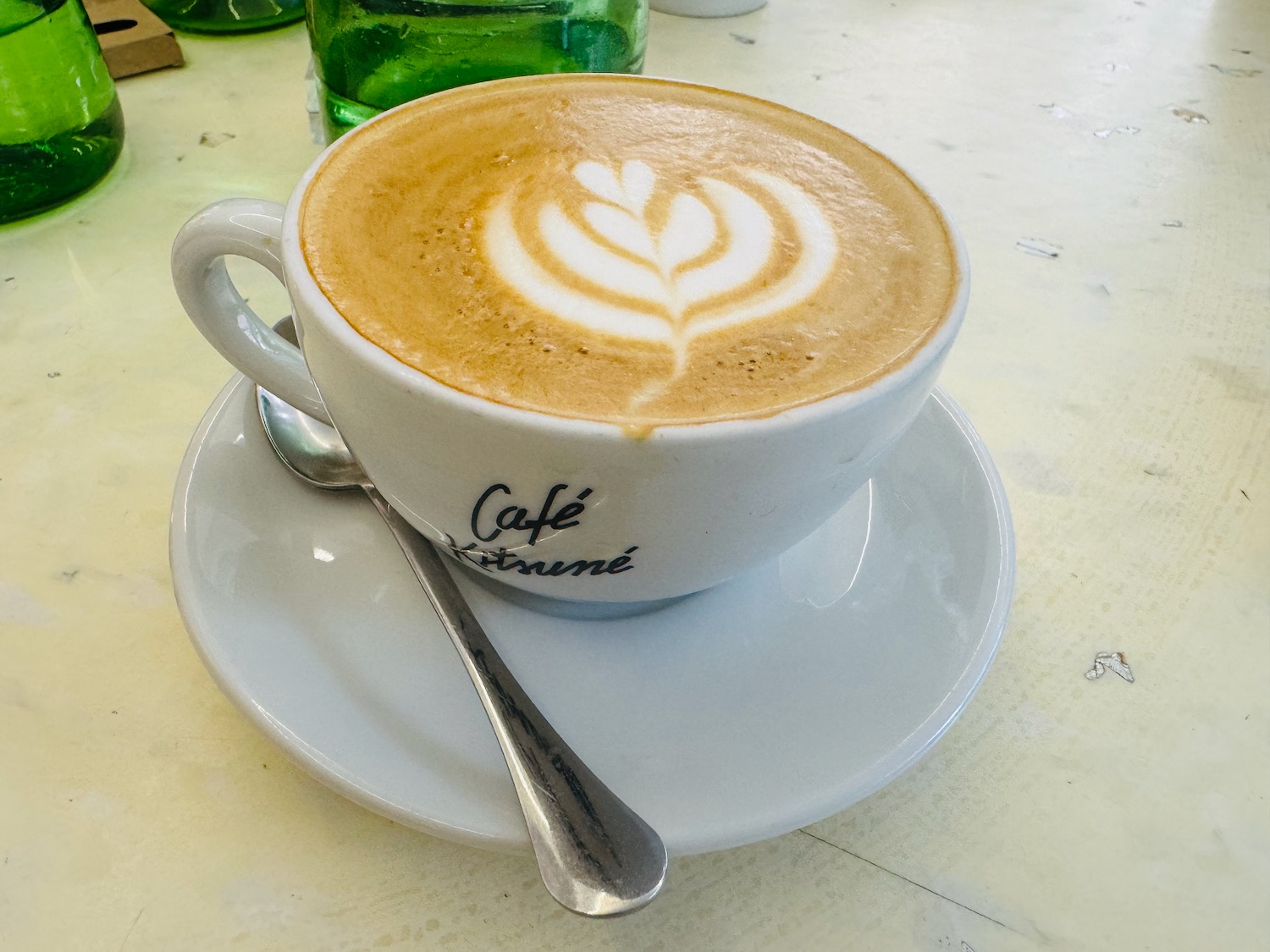 a cup of coffee with a design on the foam