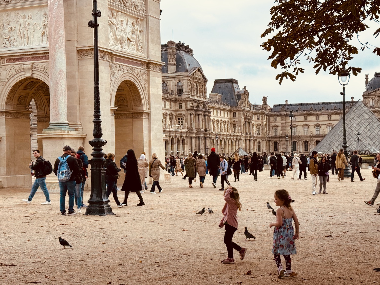 a group of people walking in a courtyard