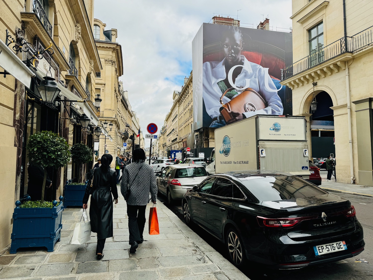 people walking on a sidewalk in a city