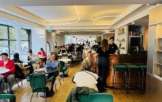 a group of people sitting at tables in a restaurant