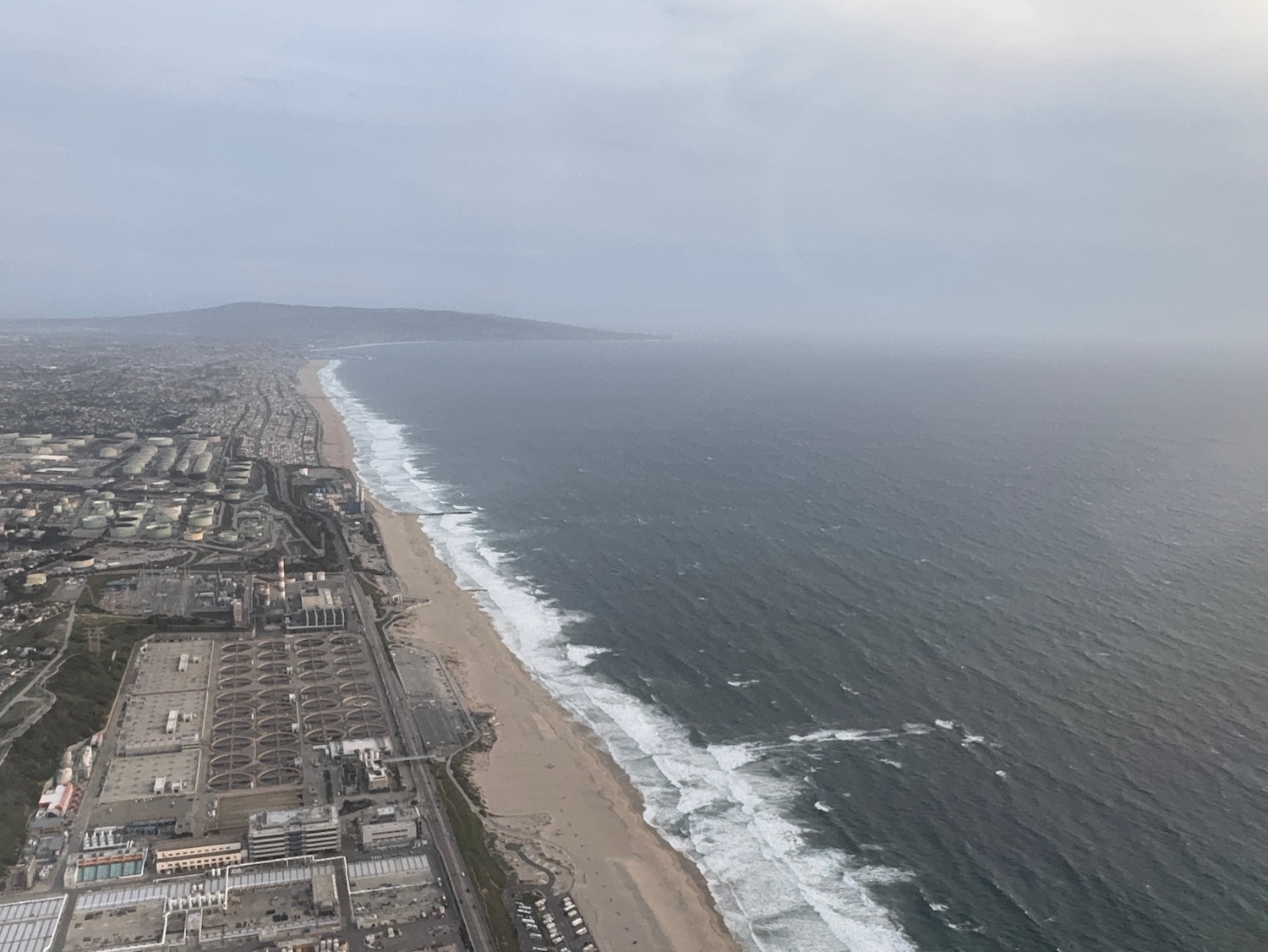 a beach with buildings and water