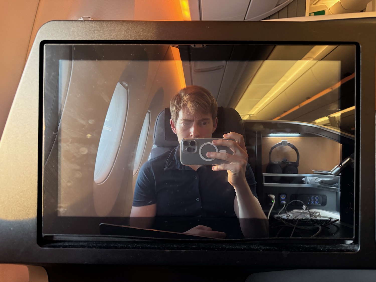 a man taking a selfie in a plane