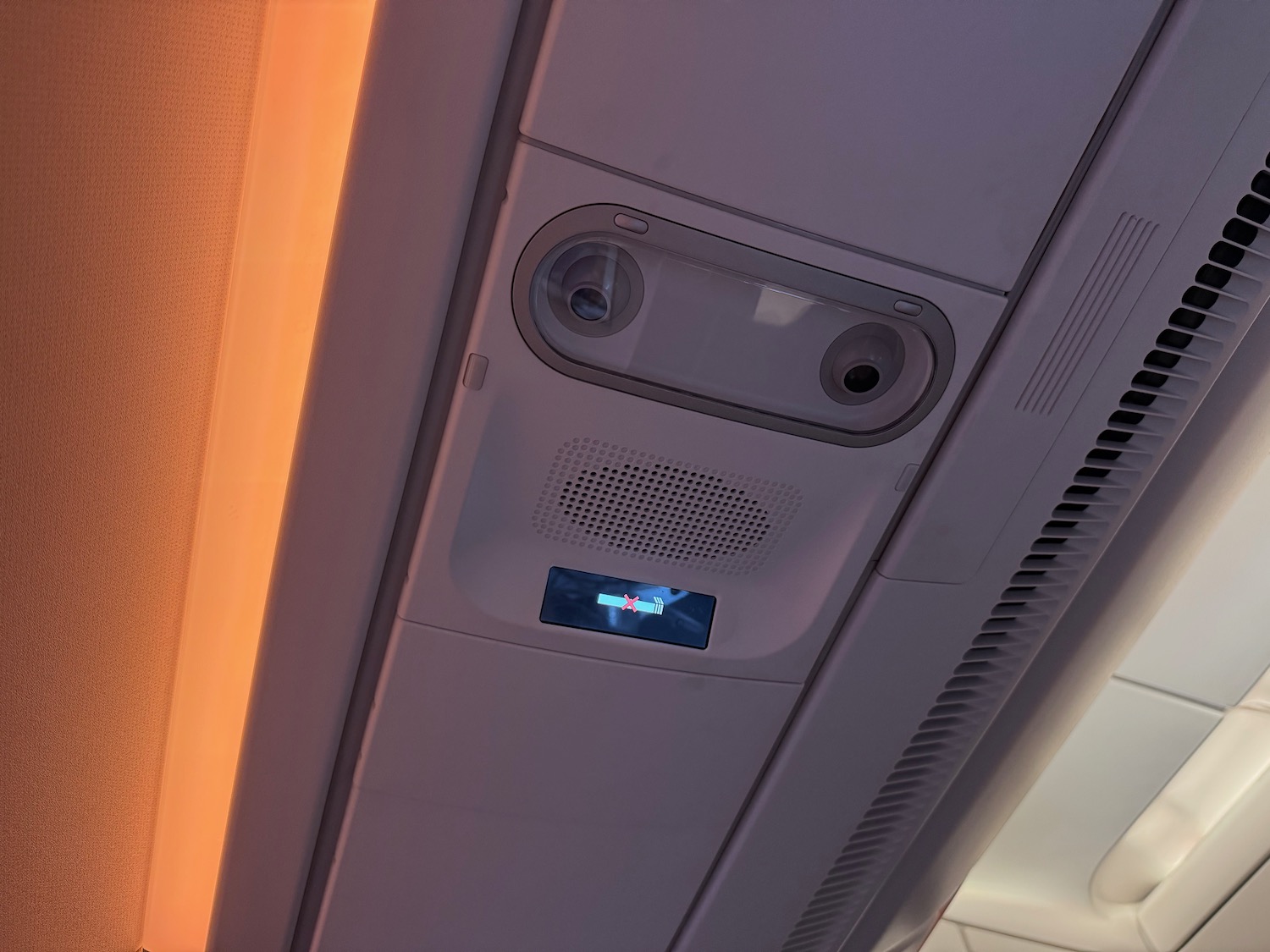 a ceiling with a speaker and a screen