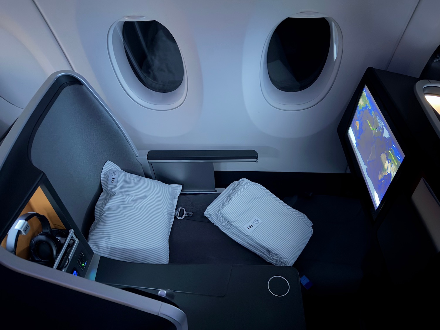 a seat with a tv and a screen in the middle of the seat