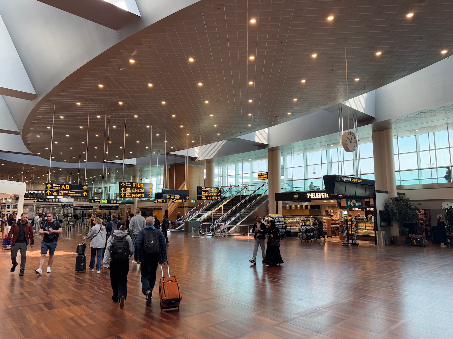 a group of people walking in a large airport terminal