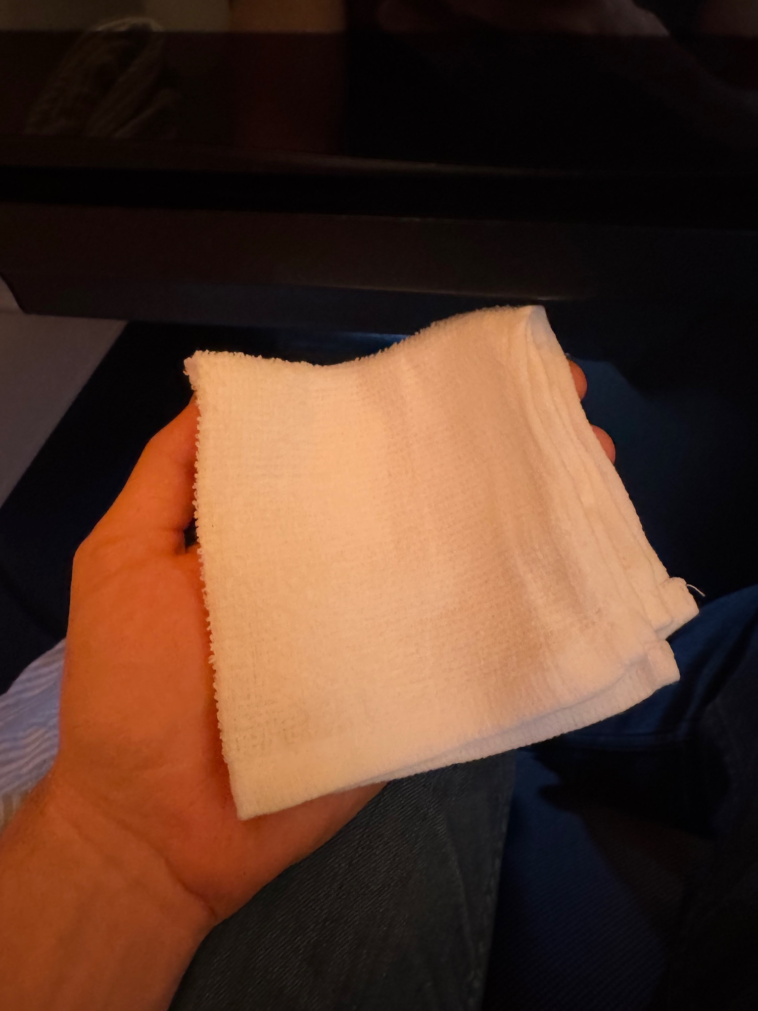 a hand holding a white towel