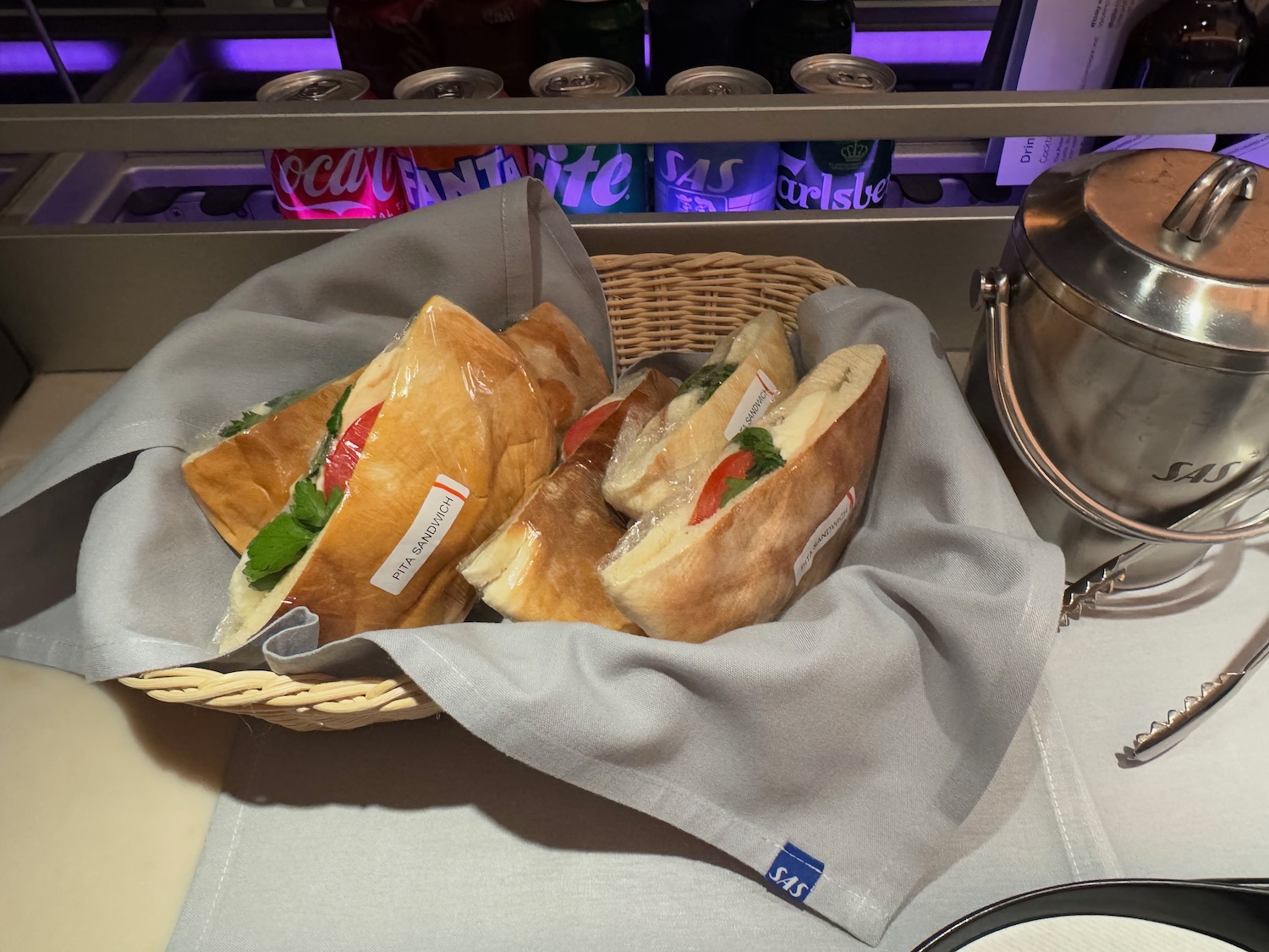 a basket of sandwiches on a towel