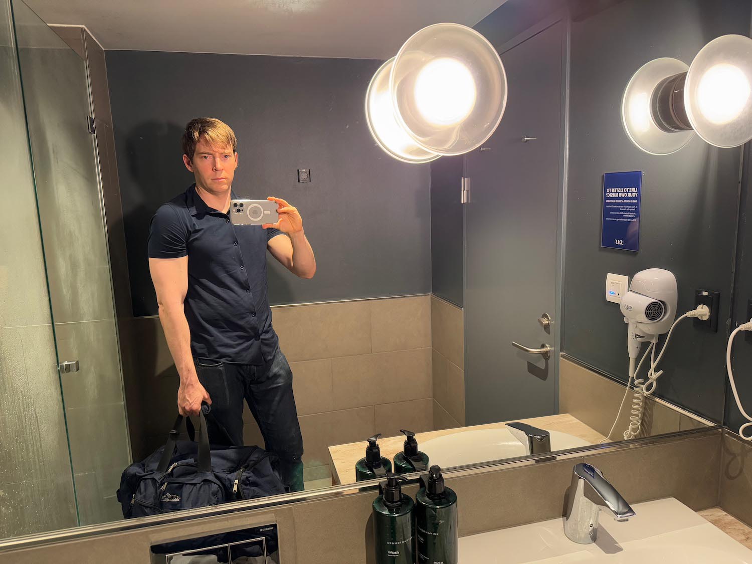 a man taking a selfie in a bathroom