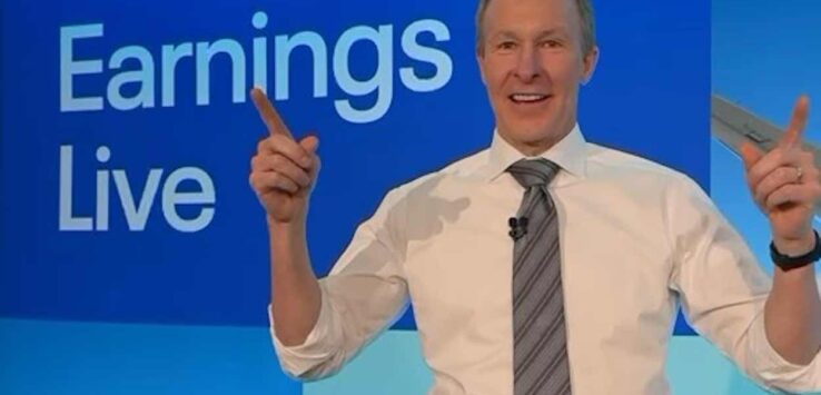 a man in a suit and tie pointing at something