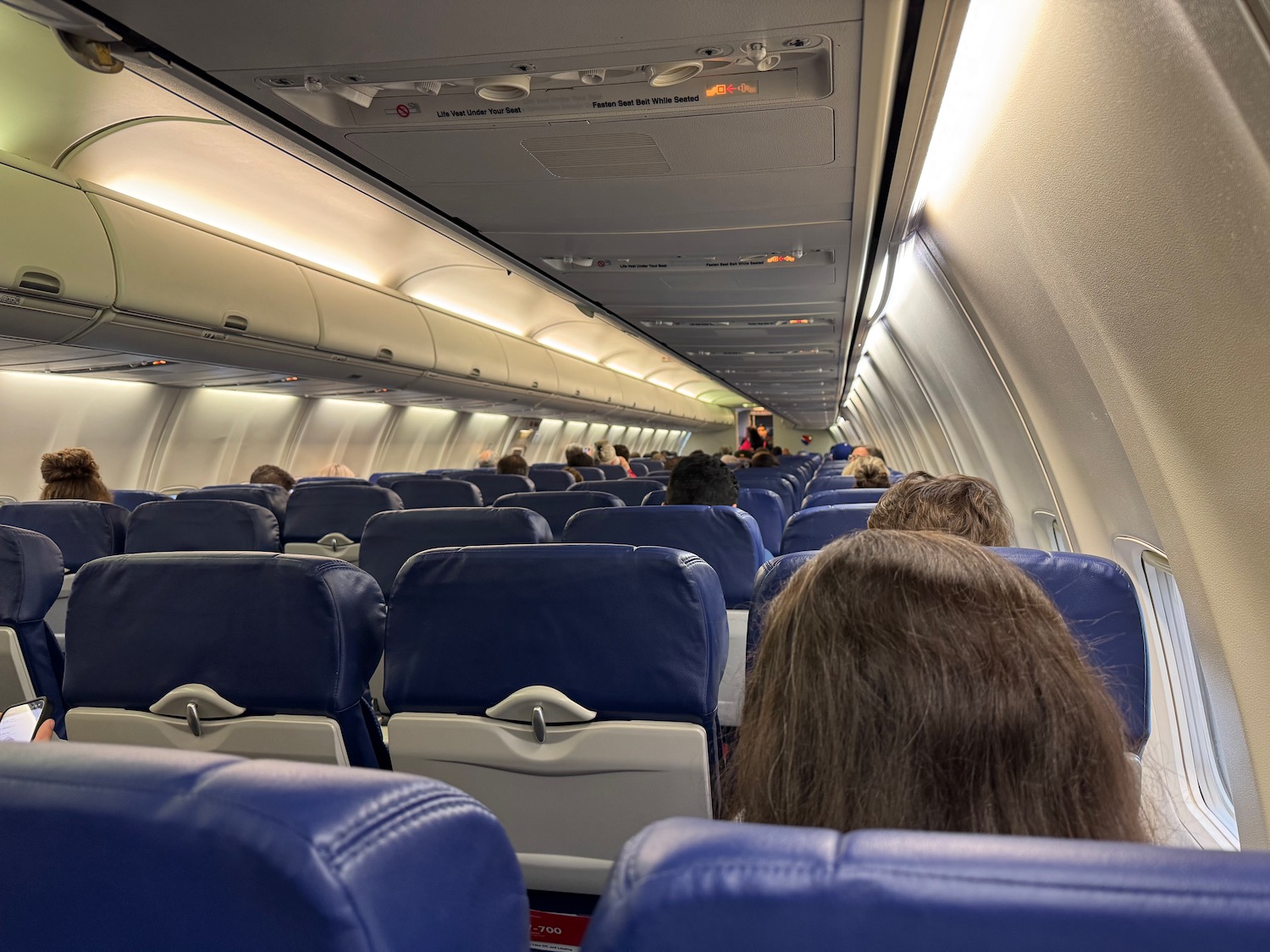 a group of people sitting in an airplane