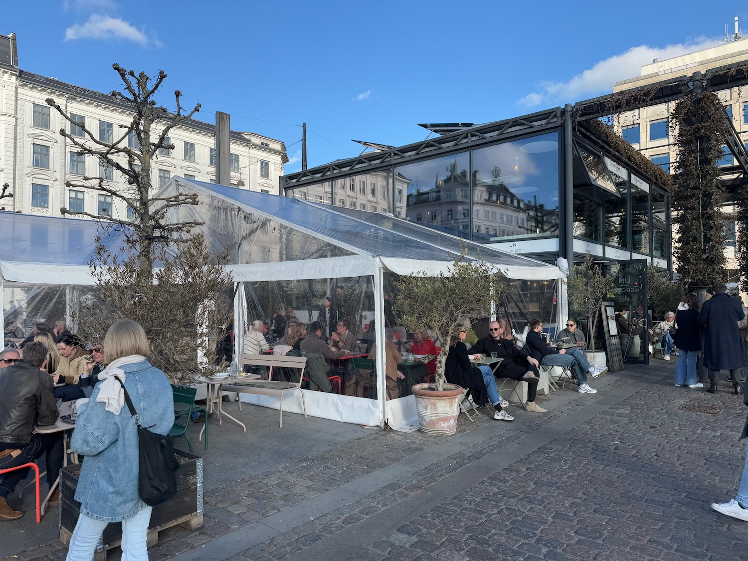 a group of people sitting outside a restaurant