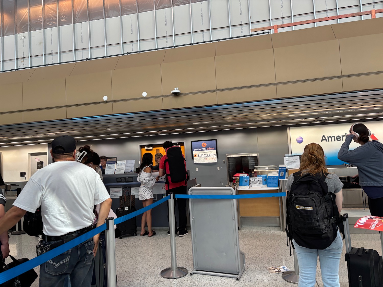 people standing in line at a check-in counter
