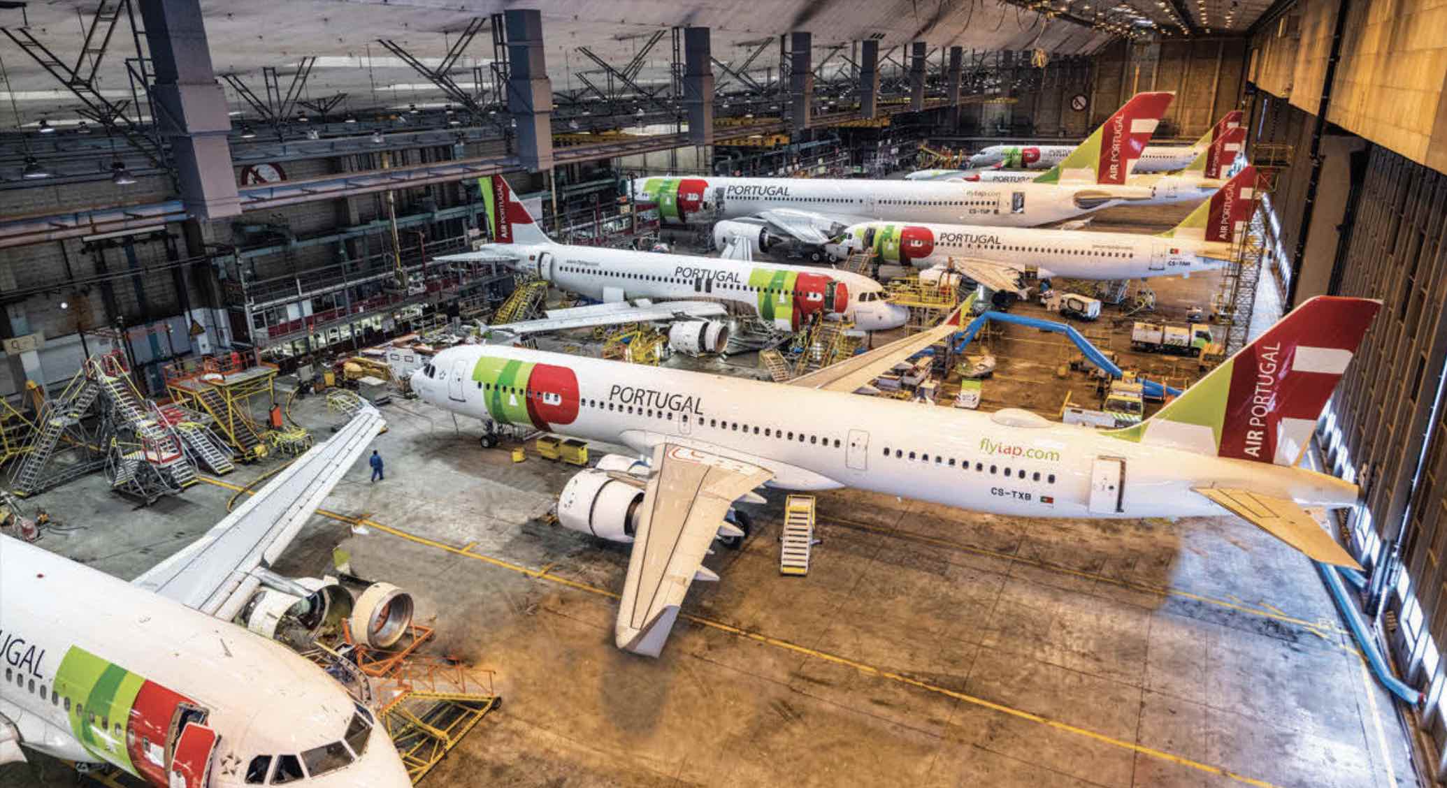 several airplanes in a hangar