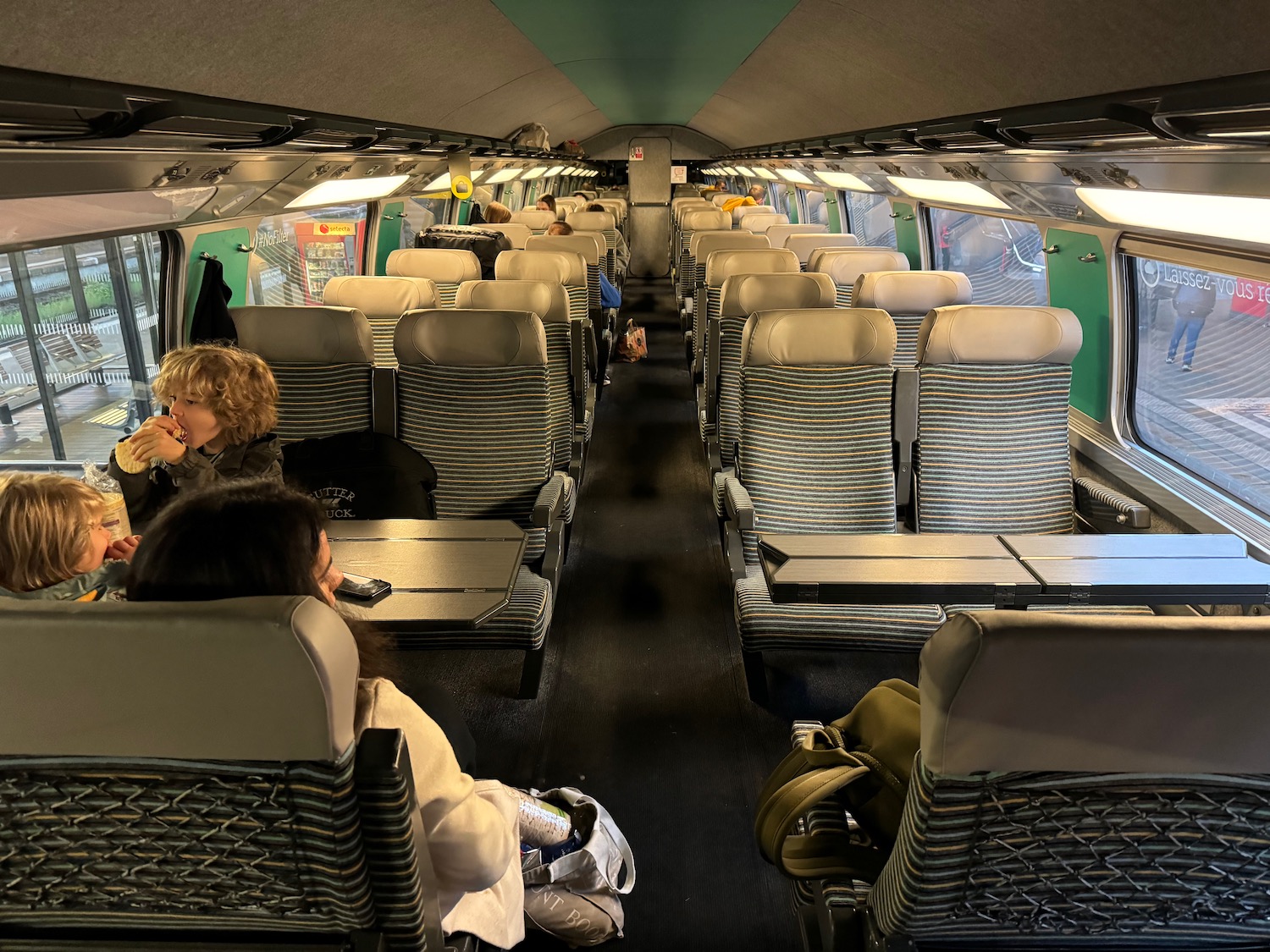 a group of people sitting in a train