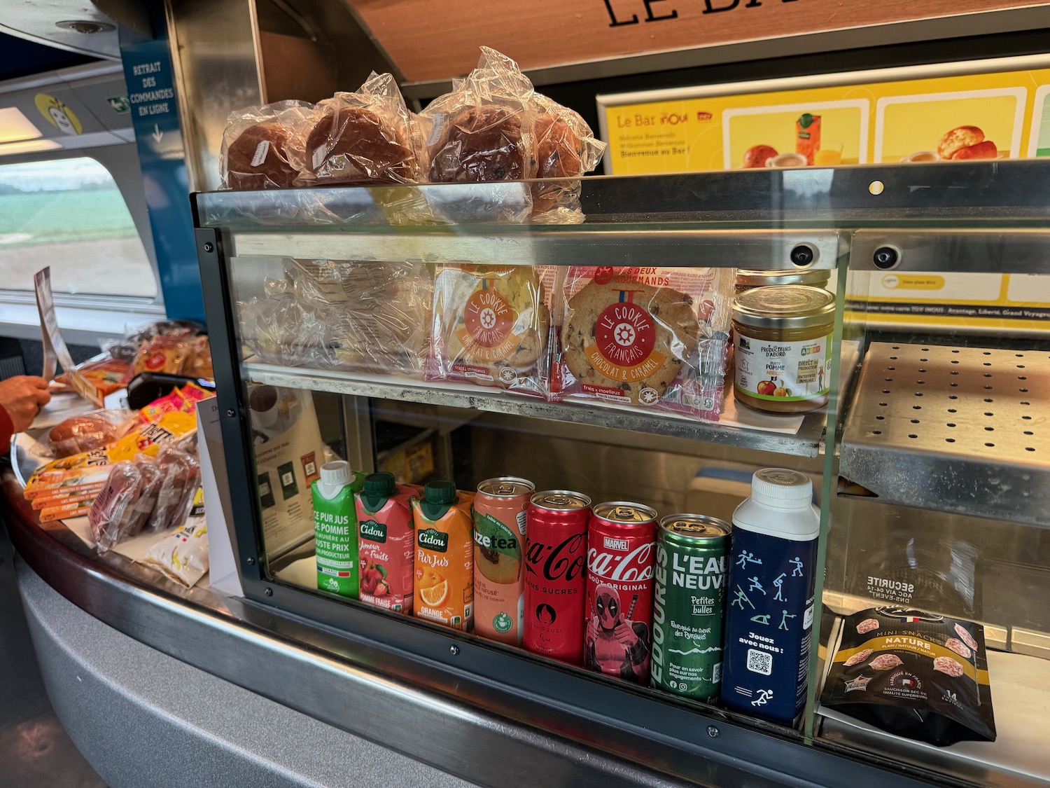 a display case with food and drinks