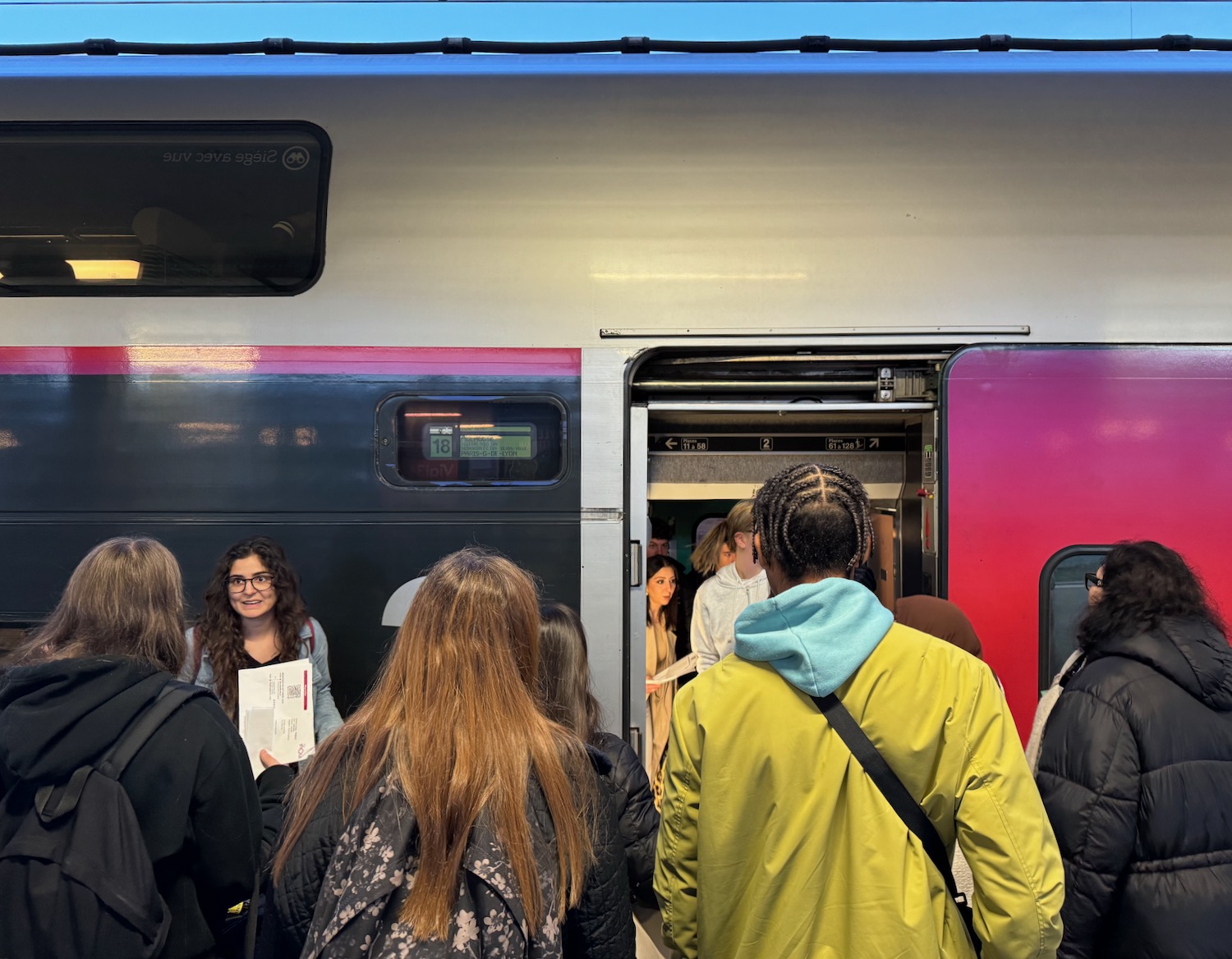 a group of people standing in front of a train