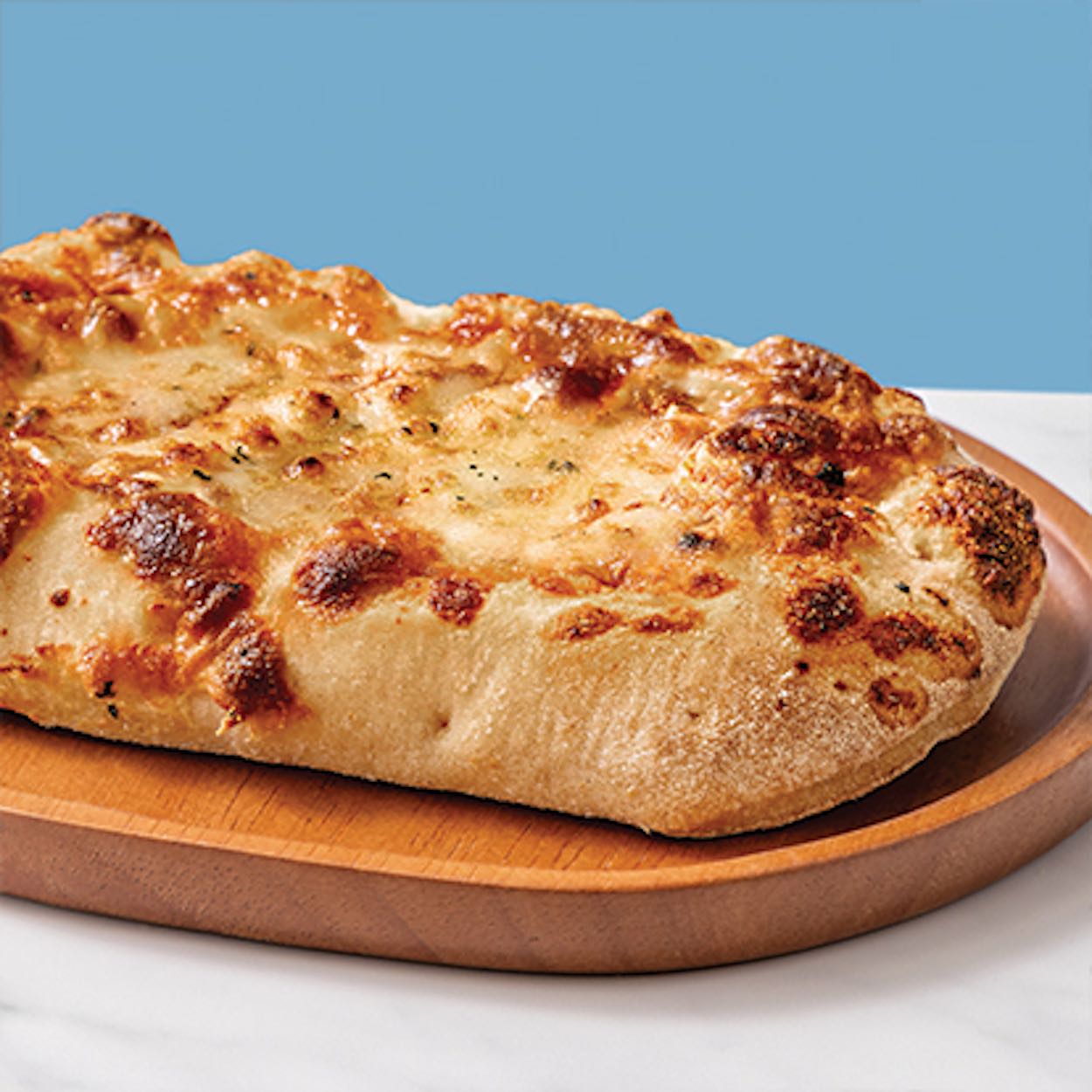 a pizza on a wooden plate