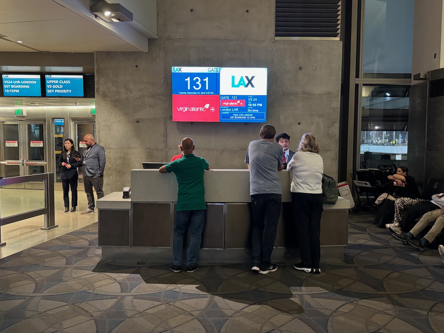 people standing at a counter in a building