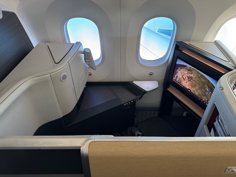 a seat and a television in an airplane