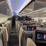 an airplane with rows of seats and monitors