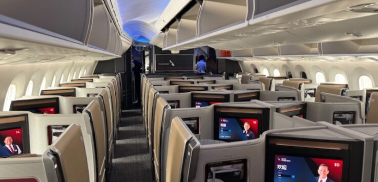 an airplane with rows of seats and monitors