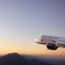 a plane flying over mountains