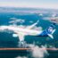 an airplane flying over a bridge