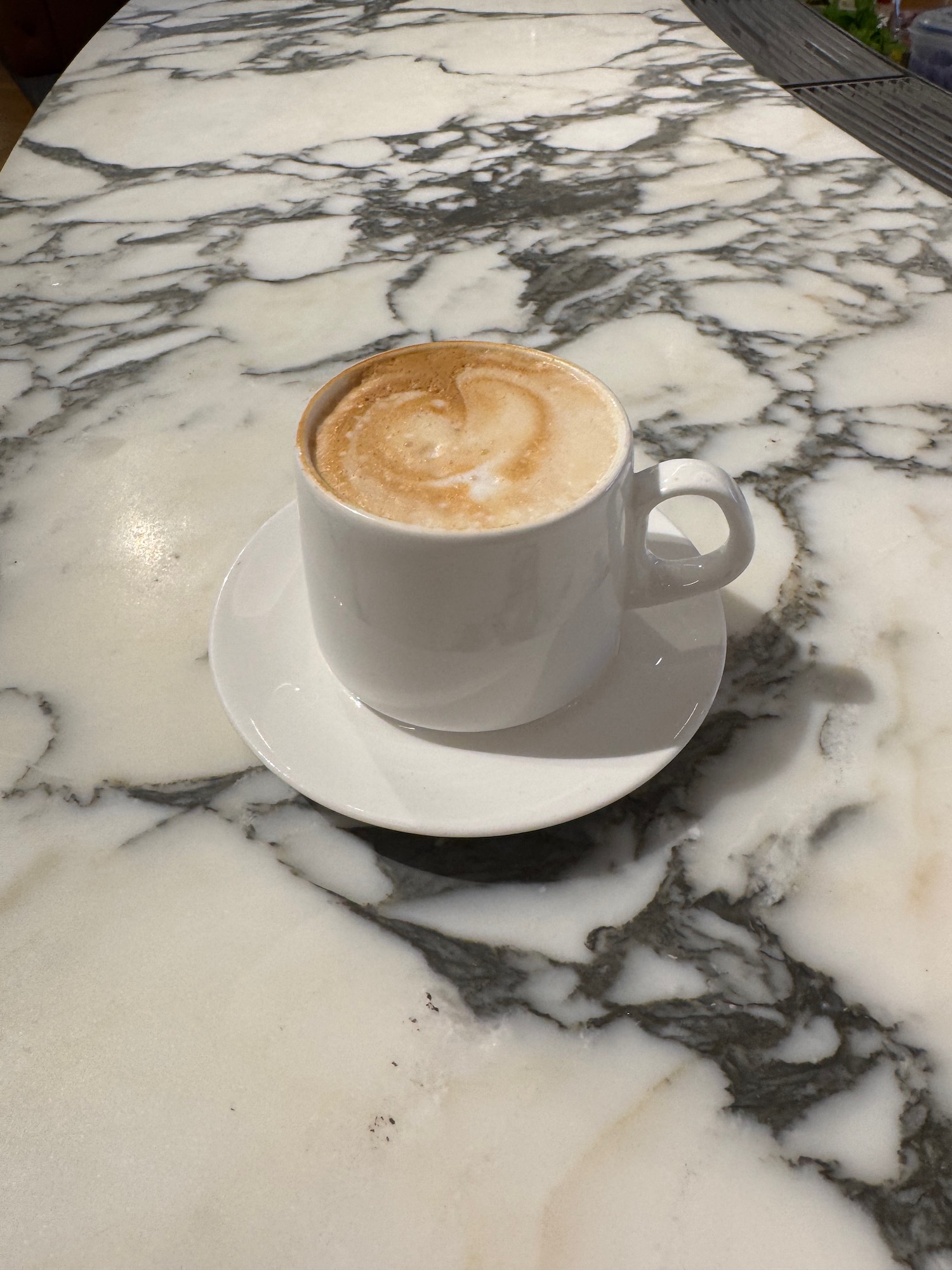 a cup of coffee on a marble table