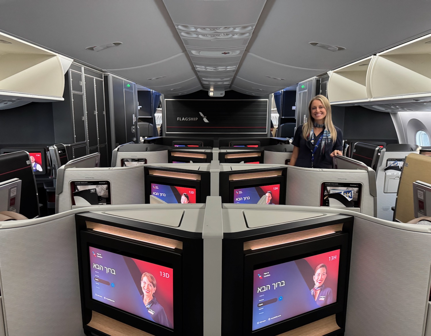 a woman standing in a room with several monitors