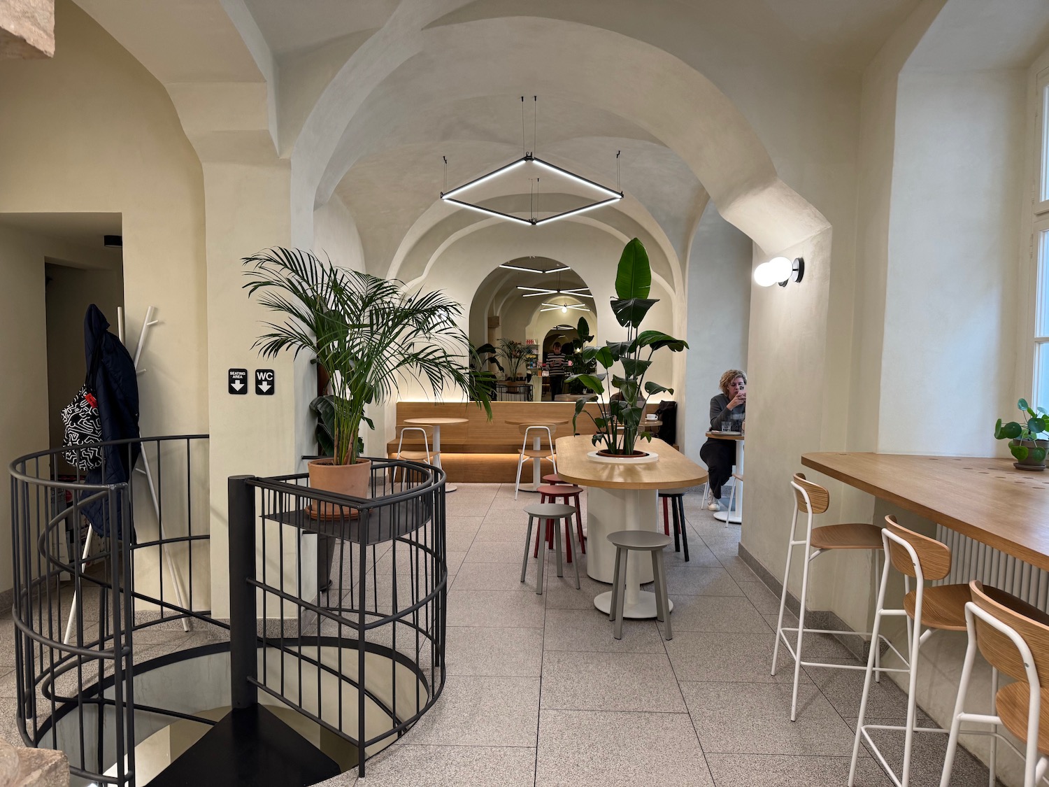 a room with tables and chairs and a staircase