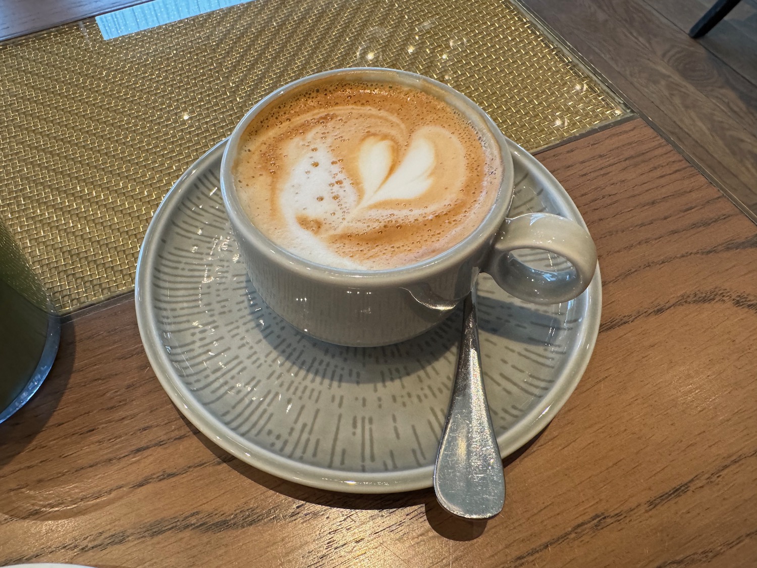 a cup of coffee with a heart shaped foam on top of it