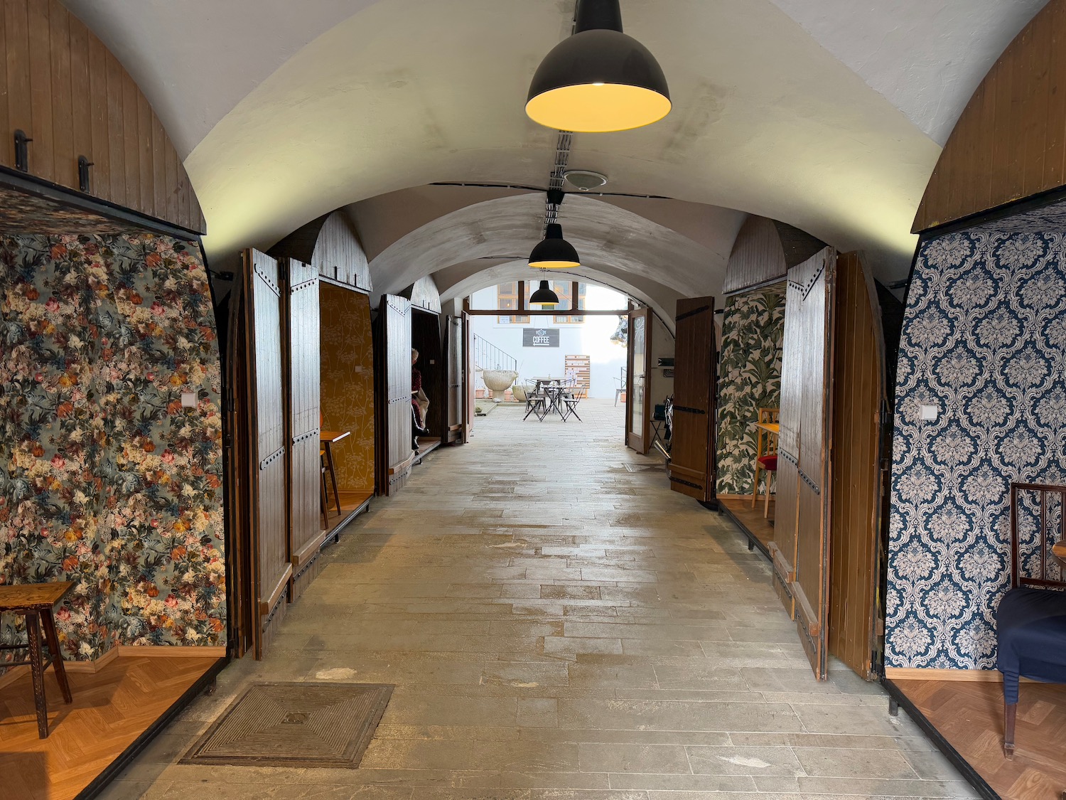 a hallway with wooden doors and a table