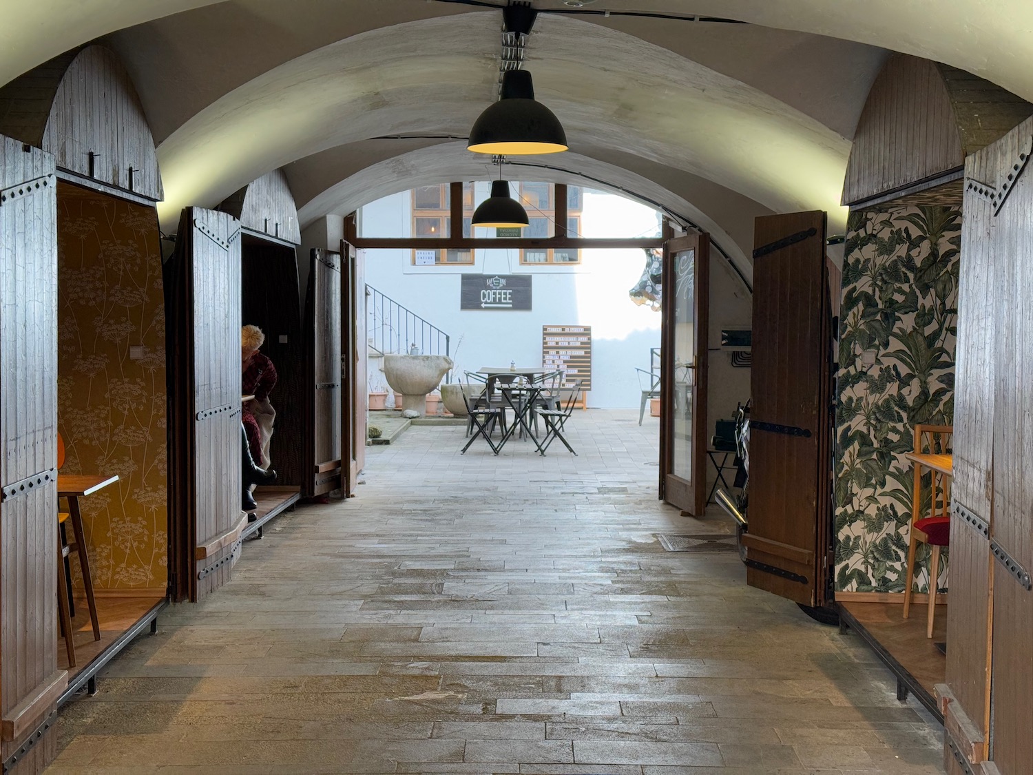 a hallway with a table and chairs