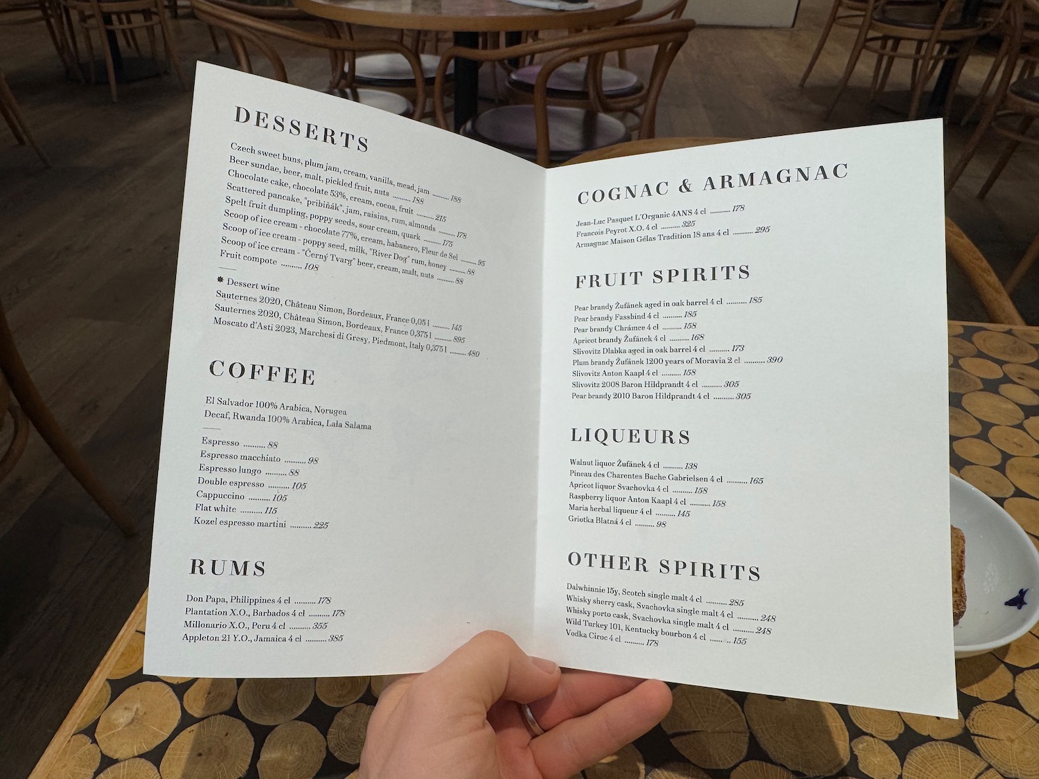 a hand holding a menu