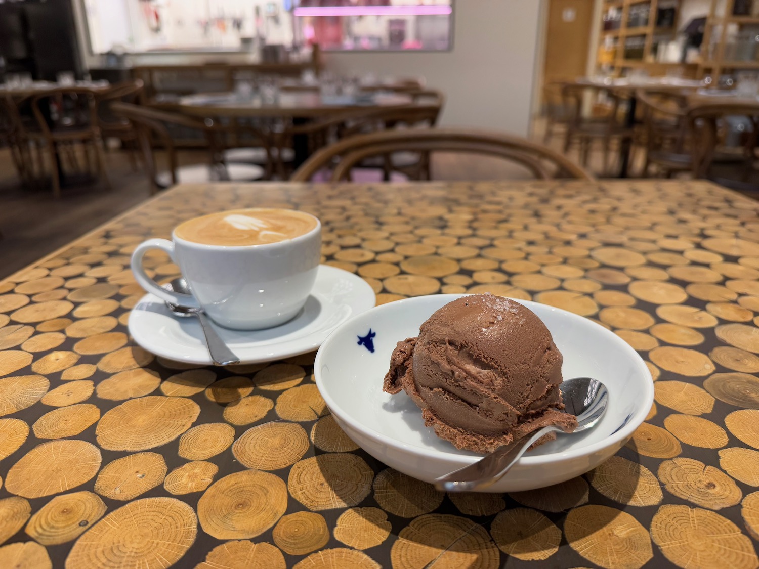 a bowl of ice cream and a cup of coffee on a table