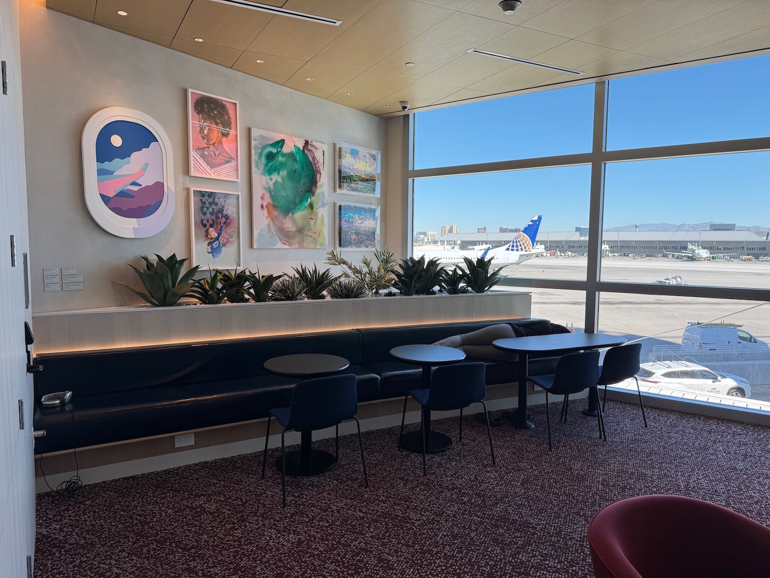 a room with a window and chairs and tables