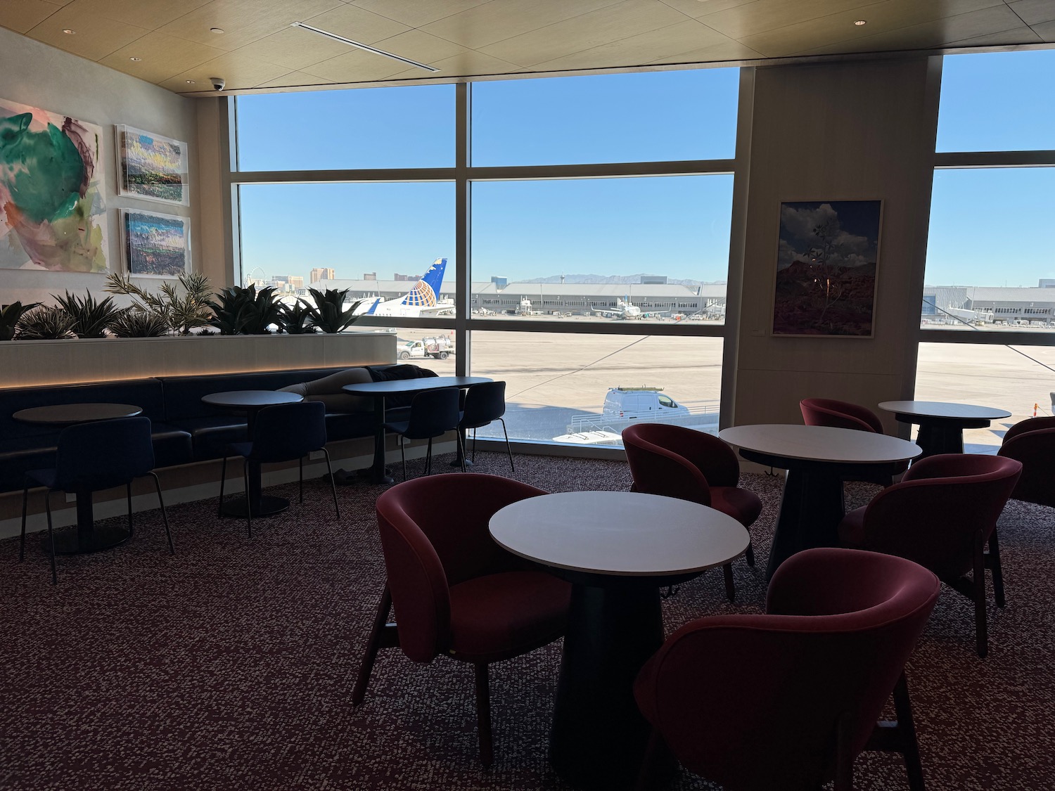 a room with tables and chairs and a window