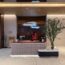 a woman standing at a desk in a lobby